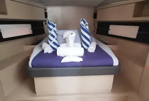 Luxurious cabin interior of 2020 Beneteau Oceanis 46.1 yacht with neatly arranged bedding.