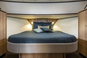 Luxurious bedroom interior of 2025 Linssen 45 SL Sedan yacht with elegant bedding.