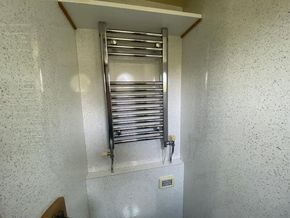 En suite towel rail plus high shelf