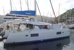 2020 Lagoon 42 catamaran docked at marina with other sailboats.