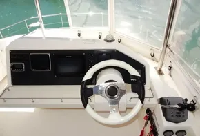 2017 Leopard 43 Powercat helm station with steering wheel and navigation controls.
