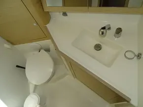 Bathroom interior of 2017 Beneteau Oceanis 45 yacht, featuring sink and toilet.