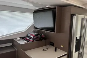 Interior of 2024 Leopard 40 Powercat with TV, refrigerator, and modern cabinetry.