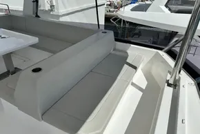 2025 Robertson and Caine Leopard 46 Powercat interior seating area with table and cup holders.