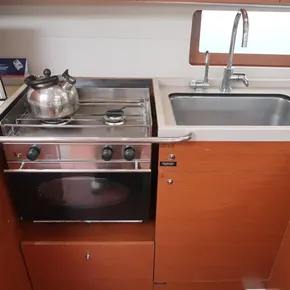 Beneteau Oceanis 51.1 2018 yacht kitchen with stove, oven, and sink.