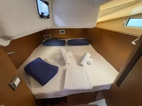 Cozy cabin interior of 2019 Jeanneau Sun Odyssey 440 with neatly arranged bedding.