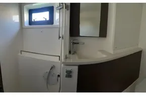 Modern bathroom interior in a 2022 Leopard 45 yacht, featuring sleek fixtures and a window.