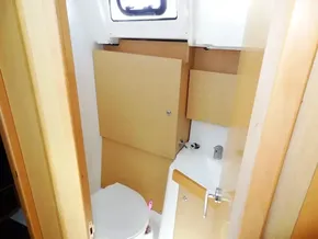 Beneteau Oceanis 38 2017 model bathroom with wooden cabinets and compact sink.