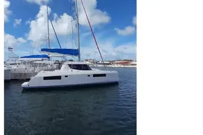 2018 Leopard 45 catamaran docked in marina under clear blue sky.
