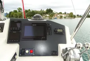 Leopard 45 yacht helm with navigation equipment, 2017 model, on a serene waterway.