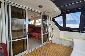 Interior view of 1989 Princess 35 Flybridge yacht with sliding doors and seating area.