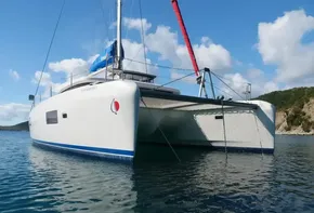 2020 Lagoon 42 catamaran anchored in calm waters under a clear blue sky.