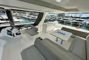 Luxurious 2022 Leopard 53 Powercat yacht interior with seating and marina view.