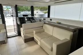 Interior of 2022 Leopard 53 Powercat with modern helm and beige seating.