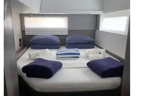 Luxurious cabin interior of 2022 Leopard 45 yacht with neatly arranged bedding.