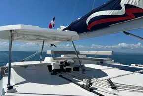 2022 Leopard 42 catamaran deck with sails, ocean view, and clear blue sky.