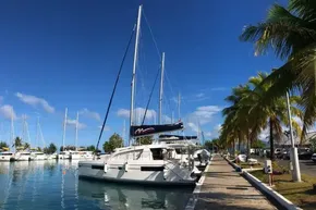2020 Leopard 40 catamaran docked at a marina under clear blue skies.
