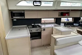 Modern kitchen interior of 2023 Beneteau Oceanis 51.1 yacht with sleek cabinetry and appliances.