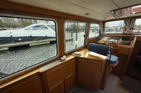 Interior view of 1994 Linssen 360 AC yacht with wooden helm and large windows.