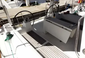 2017 Beneteau Oceanis 38 sailboat cockpit with dual steering wheels and docked at marina.