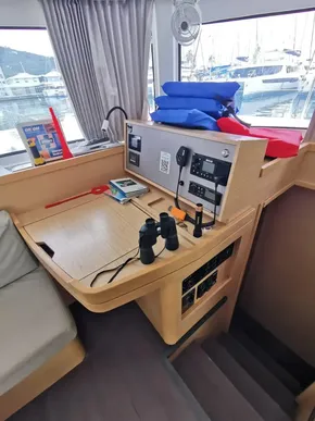 Interior of 2020 Lagoon 42 yacht with navigation station and marina view.