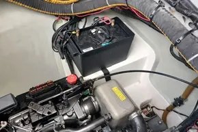 Engine compartment of a 2017 Leopard 48 with battery and wiring.