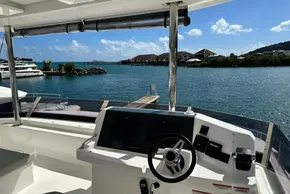 2025 Robertson and Caine Leopard 46 Powercat helm with scenic marina view.