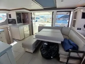Interior of 2019 Leopard 45 catamaran with dining area and marina view.