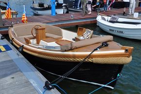 2026 Enkhuizensloep 615 boat docked, featuring wooden deck and beige seating.