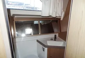 2017 Beneteau Oceanis 41 bathroom with sink, mirror, and toilet.