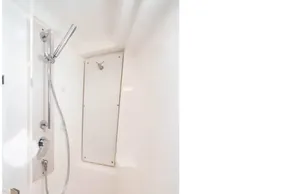 Modern shower area in 2025 Leopard 46 yacht, featuring sleek fixtures and white interior.