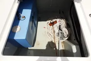 Storage compartment of a 2017 Leopard 43 Powercat with rope and blue tank.