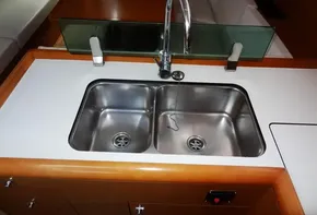 Stainless steel double sink in the galley of a 2017 Jeanneau Sun Odyssey 389 sailboat.