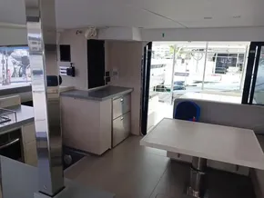 Modern interior of a 2021 Leopard 40 catamaran with sleek kitchen and dining area.