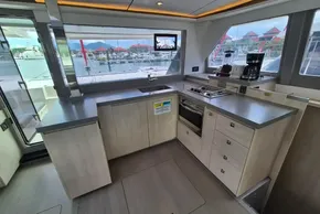 Modern kitchen interior on a 2021 Leopard 45 yacht, featuring sleek countertops and appliances.