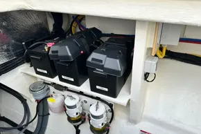 Battery compartment of 2025 Robertson and Caine Leopard 46 Powercat, featuring multiple batteries and wiring.