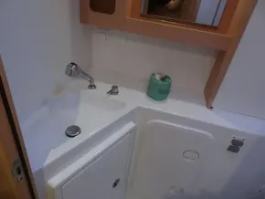 Lagoon 42 2020 model bathroom sink area with faucet and storage.