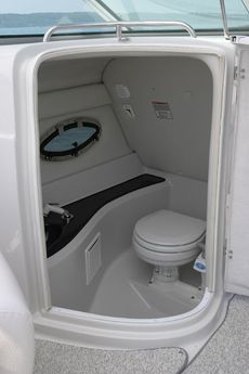 Crownline Deck Boat 262 EX - Enclosed, lighted head compartment with portable toilet, opening screened portlight and sink with shower