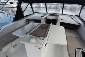 Beneteau Oceanis 46.1 2020 model cockpit with seating and table, docked at marina.