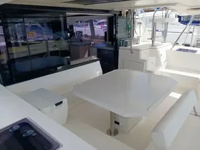 Spacious deck of 2019 Leopard 45 catamaran with seating and table.