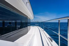 2025 Leopard 40 Powercat yacht cruising on open blue sea under clear sky.