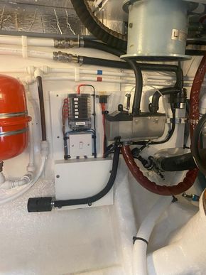 Diesel fired hot water central heating unit, showing 22mm speedfit flow & return ring circuit top left. Located engine room starboard. Above right, stbd engine room fan unit