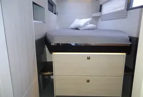 Cozy bedroom in 2017 Leopard 45 yacht with modern design and storage drawers.