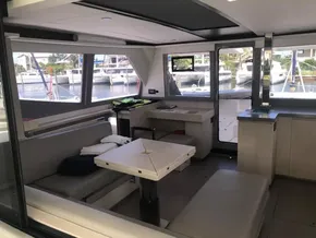 Modern interior of 2021 Leopard 45 catamaran with spacious seating and large windows.
