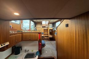 Interior of 1994 Linssen 360 AC yacht with wooden cabinetry and compact kitchen area.