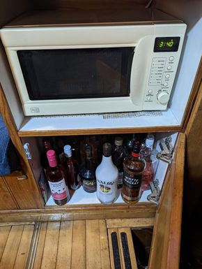 Microwave and drinks cabinet below tv