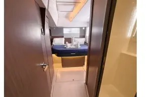 Luxurious interior of 2021 Leopard 50 yacht, featuring a cozy bedroom with elegant decor.