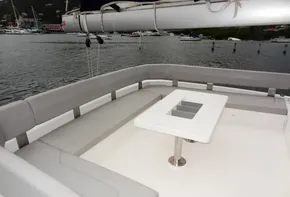 2020 Leopard 50 yacht with spacious outdoor seating and table, docked in a marina.