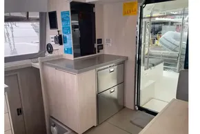 Interior of 2020 Leopard 40 catamaran with modern kitchen and outdoor view.