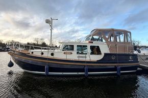 1994 Linssen 360 AC boat docked on calm water under cloudy sky.